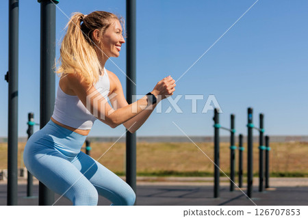 Fitness woman doing push ups from bar training at outdoor summer park closeup Fitness woman doing push ups from bar training at outdoor summer park closeup 126707853