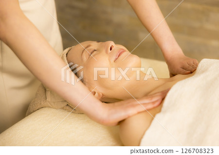 Senior woman receiving massage at beauty salon Senior woman receiving massage at beauty salon 126708323