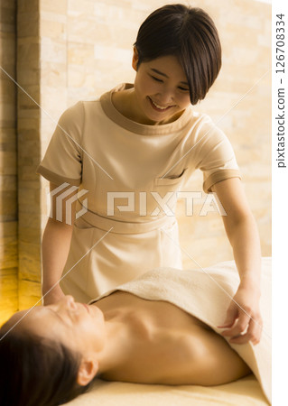 Senior woman receiving massage at beauty salon 126708334