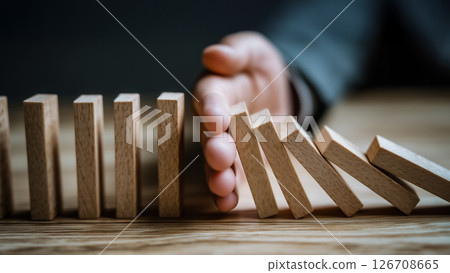 Businessman hand stopping domino effect, risk management, control and order concept, strategic action 126708665