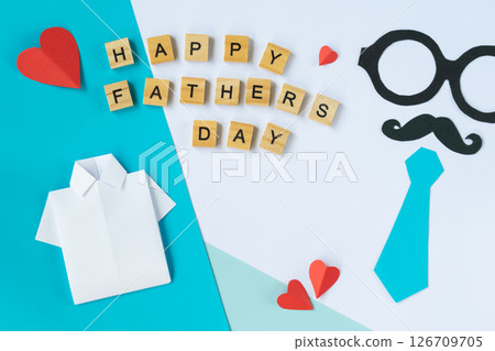 Happy Fathers Day card with shirt and tie cutouts mustache glasses red hearts wooden letters greeting background for social media flat lay paper crafts celebration elements 126709705