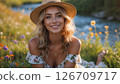 A young woman in a sunlit meadow near the river 126709717