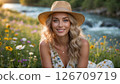 A young woman in a sunlit meadow near the river 126709719