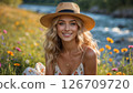 A young woman in a sunlit meadow near the river 126709720
