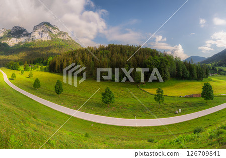 Meadow with road and bench during sunset in Berchtesgaden National Park 126709841