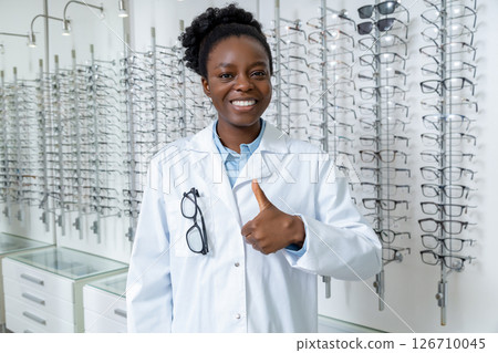 Pretty young smiling female doctor in optical shop 126710045
