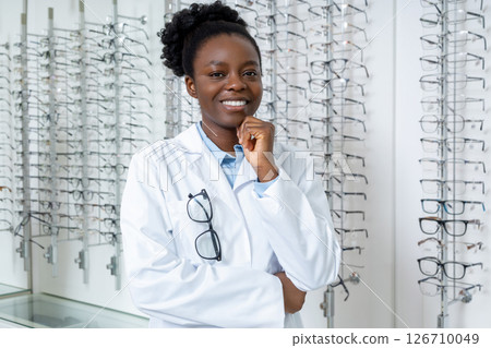 Pretty young smiling female doctor in optical shop 126710049