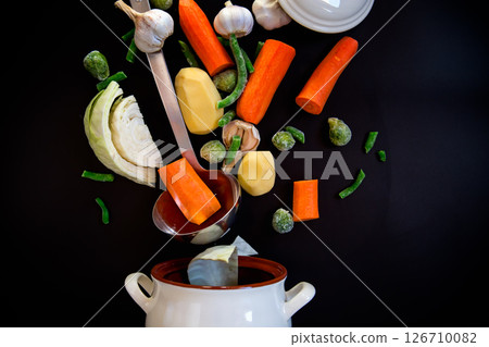 Vegetables in motion before cooking in soup Vegetables in motion before cooking in soup 126710082