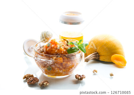 Cooked rice with pumpkin, honey and nuts. Isolated on white background Cooked rice with pumpkin, honey and nuts. Isolated on white background 126710085