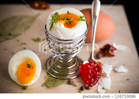 delicacy with red caviar and boiled egg for breakfast, on a wooden board 126710086