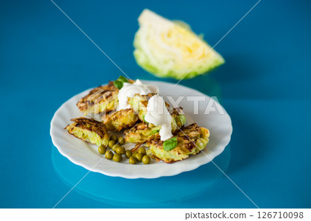 vegetable cutlets from cabbage with peas on a blue background vegetable cutlets from cabbage with peas on a blue background 126710098