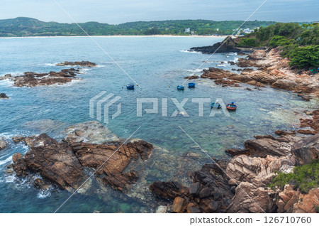 Seascape with Vietnamese round basket boats floating in the sea next to the rocks. Panoramic landscape of Da Da reef or Ganh Da Dia in Phu Yen province in Vietnam. Aerial top view from drone Seascape with Vietnamese round basket boats floating in the sea next to the rocks. Panoramic landscape of Da Da reef or Ganh Da Dia in Phu Yen province in Vietnam. Aerial top view from drone 126710760