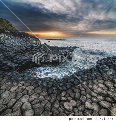 Landscape with basalt columns on the rocky beach by the sea. Da Da reef in Phu Yen province in Vietnam at sunrise 126710773