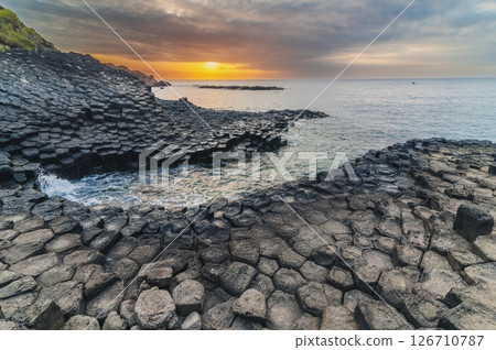 Da Dia reef or Ganh Da Dia in Phu Yen province in Vietnam at sunrise. Landscape with black volcanic basalt columns on the rocky beach by the sea 126710787