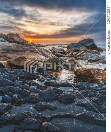 Panoramic landscape with volcanic basalt columns Ganh Da Dia on the beach by the sea. Da Dia reef in Vietnam at sunrise Panoramic landscape with volcanic basalt columns Ganh Da Dia on the beach by the sea. Da Dia reef in Vietnam at sunrise 126710834