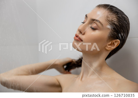 Woman washing body in bath in bathroom splashing water at home Woman washing body in bath in bathroom splashing water at home 126710835
