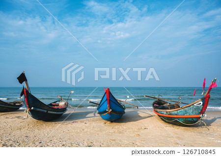Traditional wooden Vietnamese boats on beach by sea in a fishing village in Vietnam 126710845