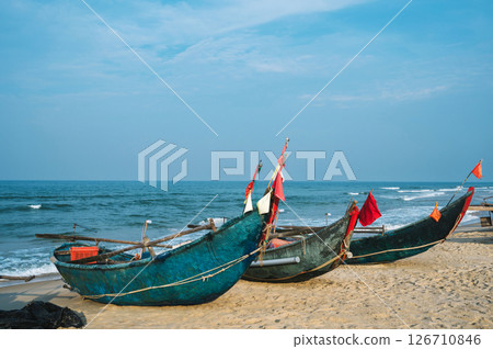Traditional wooden Vietnamese boats on beach by the sea in a fishing village in Vietnam 126710846
