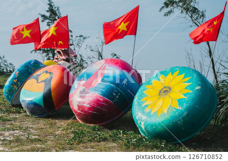 beautiful painted traditional Vietnamese boats and flag of Vietnam in Murals Paintings Fishing Village in Tam Thanh 126710852