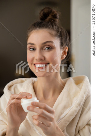 Young woman doing self-care facial routine with organic skincare products Young woman doing self-care facial routine with organic skincare products 126710870