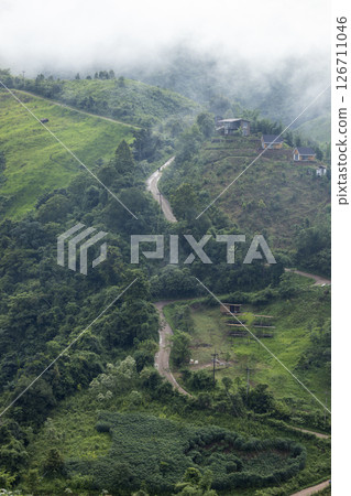 Landscape of Morning Mist with Mountain Layer. mountain ridge and clouds in rural jungle bush forest 126711046