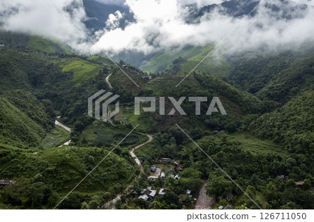 Landscape of Morning Mist with Mountain Layer. mountain ridge and clouds in rural jungle bush forest Landscape of Morning Mist with Mountain Layer. mountain ridge and clouds in rural jungle bush forest 126711050