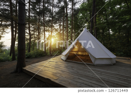 Scenic glamping site with canvas tent, wooden deck, and rustic elements. Tranquil eco-friendly concept in natural forest setting. Scenic glamping site with canvas tent, wooden deck, and rustic elements. Tranquil eco-friendly concept in natural forest setting. 126711449