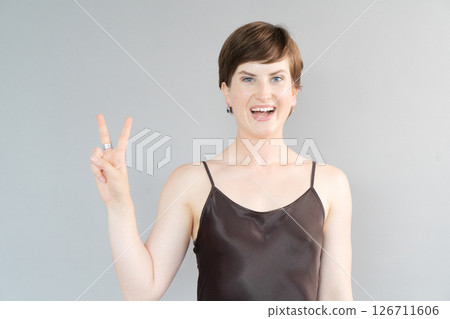 Happy young girl isolated over gray background Happy young girl isolated over gray background 126711606