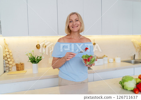 Healthy Cooking in a Modern Kitchen A Woman Skillfully Preparing Fresh, Colorful Vegetables with Care Healthy Cooking in a Modern Kitchen A Woman Skillfully Preparing Fresh, Colorful Vegetables with Care 126711637