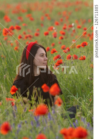 Young Woman in Poppy Field with Red Hat Young Woman in Poppy Field with Red Hat 126711885