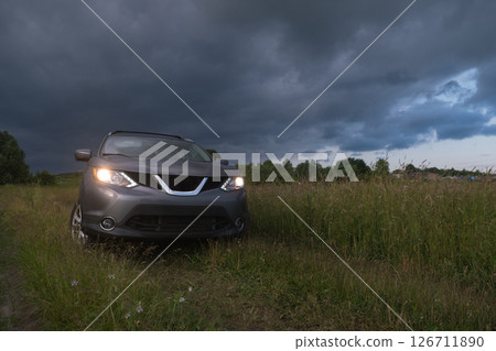 SUV in a Field Under Dramatic Skies 126711890