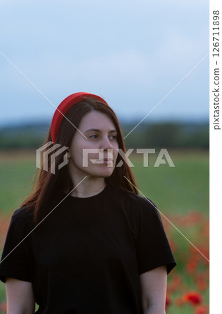 Young Woman in Poppy Field with Red Hat Young Woman in Poppy Field with Red Hat 126711898