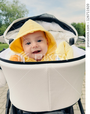 Smiling Baby in Yellow Hoodie in Stroller Smiling Baby in Yellow Hoodie in Stroller 126711920