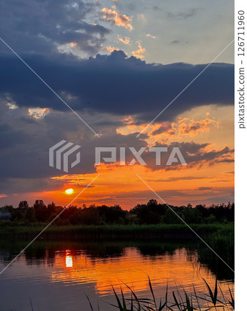 Serene Sunset Reflection Over a Tranquil Lake 126711960