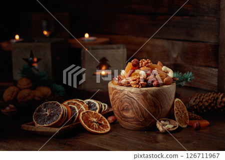 Dried fruits and assorted nuts on an old wooden table. 126711967