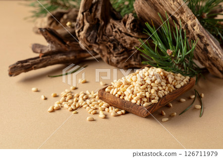 Peeled pine nuts with cedar snags and green branches. 126711979