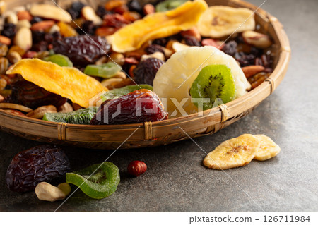 Dried tropical fruits with various nuts and raisins. 126711984