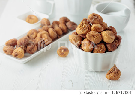 Organic dried figs on a white table. 126712001
