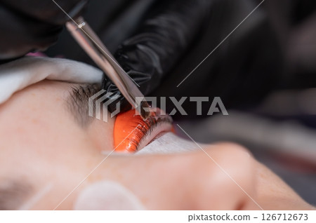 Caucasian woman undergoing eyelash lamination procedure. Caucasian woman undergoing eyelash lamination procedure. 126712673