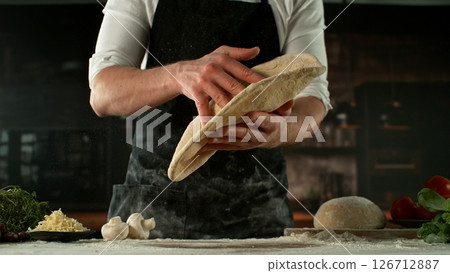 Freeze Motion of Chef Making Yeast Dough . Closeup of Bread or Pizza Dough Preparation Freeze Motion of Chef Making Yeast Dough . Closeup of Bread or Pizza Dough Preparation 126712887