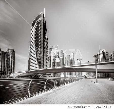 Skyscrapers and bridge over water, black and white style, city background, Dubai Marina bay UAE Skyscrapers and bridge over water, black and white style, city background, Dubai Marina bay UAE 126713195
