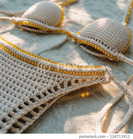 Crochet Bikini Set With Golden Beads on a Beach 126713912