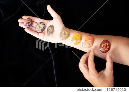 Healing crystals on female hand background, seven chakra stones Healing crystals on female hand background, seven chakra stones 126714010