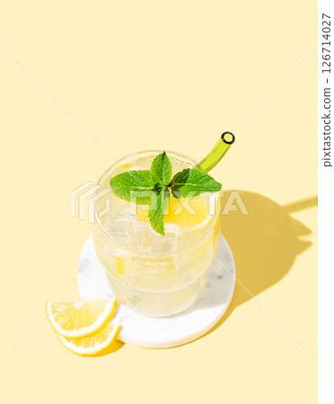 Fresh mocktail mojito with lemon, mint and ice. Citrus lemonade on a yellow background. 126714027