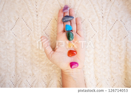 Healing crystals on female hand background, seven chakra stones 126714053