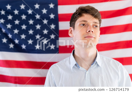Young guy posing in front of USA flag Young guy posing in front of USA flag 126714179
