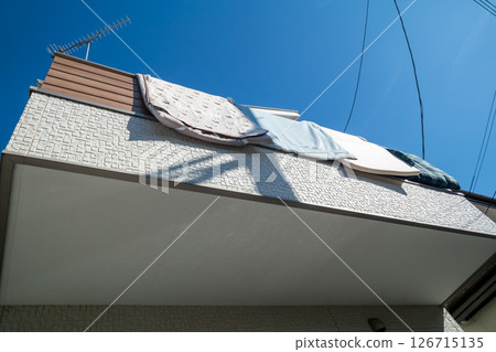 A house where futons are hung out to dry 126715135