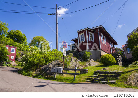 Picturesque colony of old small wooden historic houses on the Slottsberget mountain on the banks of the Gota alv river, Gothenburg, Sweden, sunny day Picturesque colony of old small wooden historic houses on the Slottsberget mountain on the banks of the Gota alv river, Gothenburg, Sweden, sunny day 126716202