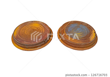 Two cast-iron inspection manhole covers of wells, covered with light rust, isolated on transparent white background. Technical products for maintaining operability of underground utility systems, 126716703