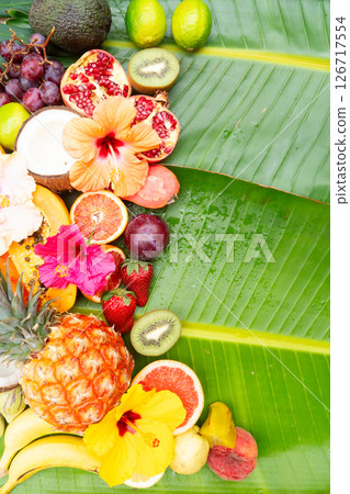 Summer mix of tropical fruits over green leaf 126717554